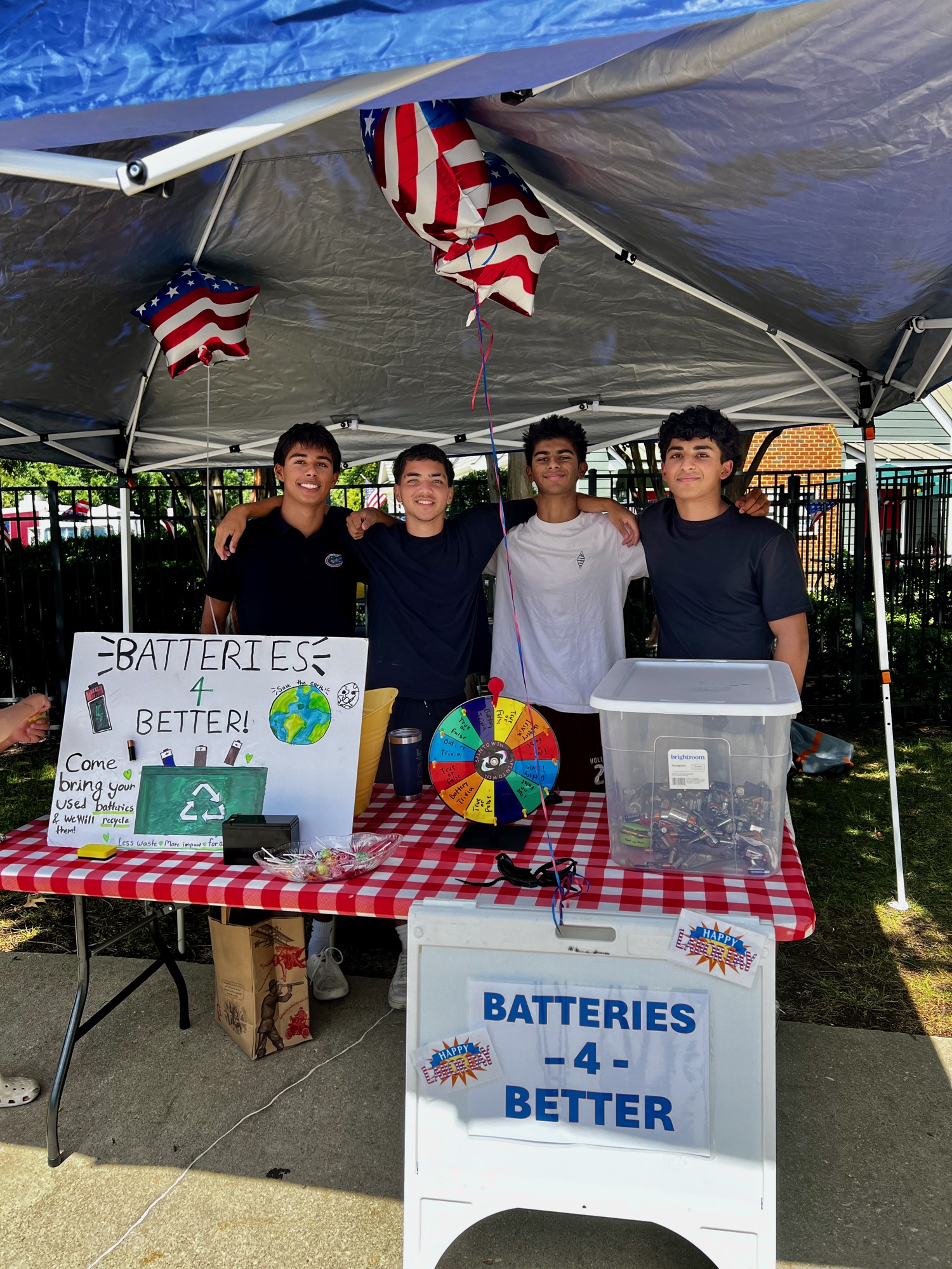 Batteries4Better volunteers behind their battery collection booth